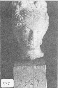 Terracotta Woman's Head with Hair Pulled up to a Bow on Top image